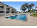 Fenced in outdoor pool with plenty of lounge chairs for relaxing in the sun at 204 Maison Dr. # N304, Myrtle Beach, SC 29572