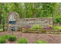 Stone community entrance sign with the name Windjammer Village and nautical decor surrounded by foliage at 2128 Adams Circle, Little River, SC 29566