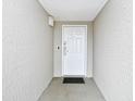 Apartment entrance with neutral colored walls, white door with unit number and a black mat at 2151 Bridge View Ct. # 2302, North Myrtle Beach, SC 29582