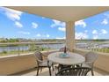 Relaxing balcony with outdoor dining furniture, perfect for enjoying the waterfront view at 2151 Bridgeview Ct. # 3-405, North Myrtle Beach, SC 29582