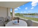 Cozy balcony with seating, offers a scenic view of the waterway, trees, and blue sky at 2151 Bridgeview Ct. # 3-405, North Myrtle Beach, SC 29582