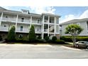 Well-maintained condo building featuring multiple stories, exterior staircases, and green landscaping at 224 Castle Dr. # 1408, Myrtle Beach, SC 29579