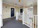 Hallway with black doors leading to units and stairs, along with a clearly marked exit sign overhead at 224 Castle Dr. # 1408, Myrtle Beach, SC 29579