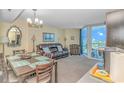 Cozy condo living room with dining table and access to balcony with ocean view at 2301 S Ocean Blvd. # 1202, North Myrtle Beach, SC 29582