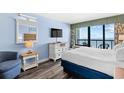 Comfortable bedroom with TV, dresser, and a view of the ocean from the window at 2401 S Ocean Blvd. # 752, Myrtle Beach, SC 29577