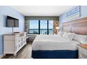 Bedroom featuring ocean views, a dresser, and a comfortable queen bed at 2401 S Ocean Blvd. # 752, Myrtle Beach, SC 29577