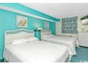 Comfortable bedroom with bright blue walls and two beds at 2801 S Ocean Blvd. # 339, North Myrtle Beach, SC 29582