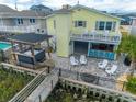 Backyard oasis with hot tub, bar, and patio, perfect for entertaining and relaxation at 314 45Th Ave. N, North Myrtle Beach, SC 29582