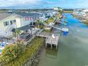 Waterfront backyard featuring a covered pavilion, dock, boardwalk, and serene water views at 314 45Th Ave. N, North Myrtle Beach, SC 29582