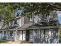 Charming townhouse exterior with gray siding, white doors, and manicured landscaping at 3700 Golf Colony Lane # 21 B, Little River, SC 29566