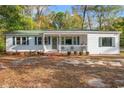 Charming single story home with white siding, green shutters, and a welcoming front porch at 3934 North Fraser St., Georgetown, SC 29440