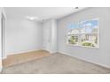 Bright living room features plush carpeting, a large window, and neutral paint, offering a welcoming space at 4009 Alvina Way, Myrtle Beach, SC 29579
