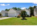 Well-maintained home with a lush green lawn and landscaped front yard at 4591 Hidden Creek Ln., Myrtle Beach, SC 29579