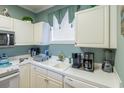 Bright kitchen with white cabinets, appliances, and ample counter space at 4741 Wild Iris Dr. # 303, Myrtle Beach, SC 29577