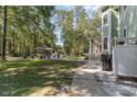 Expansive backyard featuring lush greenery, a gazebo, and a screened-in porch, ideal for outdoor entertaining at 487 Lantana Circle, Georgetown, SC 29440