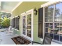 Charming front porch featuring rocking chairs, an elegant entrance and black shutters at 487 Lantana Circle, Georgetown, SC 29440