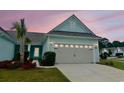 Inviting one-story home with a well-manicured lawn, complemented by a charming palm tree and light-blue siding at 5876 Cremona Dr., Myrtle Beach, SC 29577