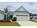 Inviting one-story home with a well-manicured lawn, complemented by a charming palm tree and light-blue siding at 5876 Cremona Dr., Myrtle Beach, SC 29577