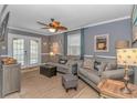 Living room with tile flooring, comfortable seating, and a french door leading to the outdoors at 6001-5610 S Kings Hwy., Myrtle Beach, SC 29575