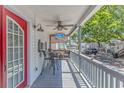 Relaxing porch with outdoor seating, ceiling fan, and mounted tv at 6001-5610 S Kings Hwy., Myrtle Beach, SC 29575
