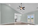 Bright living room with ceiling fan and sliding doors to the backyard at 604 Highway 747, Loris, SC 29569