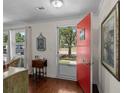 Bright entryway featuring hardwood floors, a striking red door, and abundant natural light from surrounding windows at 617 Hibiscus Ave. # 617, Myrtle Beach, SC 29577