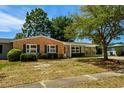 Single-story home with brick and siding, complemented by mature trees and established landscaping at 617 Hibiscus Ave. # 617, Myrtle Beach, SC 29577