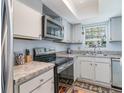 Functional kitchen features stainless steel appliances, granite countertops and ample storage space at 6734 Blue Heron Blvd. # 104, Myrtle Beach, SC 29588