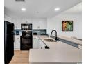 Well-lit kitchen features white cabinets and stylish backsplash at 7100 N Ocean Blvd. # 317, Myrtle Beach, SC 29572