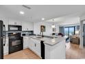 Updated kitchen with view to a bright living area and balcony at 7100 N Ocean Blvd. # 317, Myrtle Beach, SC 29572