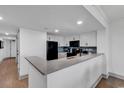 Modern kitchen with white cabinets and a sleek black refrigerator at 7100 N Ocean Blvd. # 317, Myrtle Beach, SC 29572