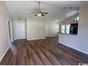 Spacious living area with wood floors, vaulted ceilings, and view of the kitchen with bar seating at 753 Bucklin Loop, Myrtle Beach, SC 29579