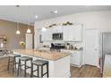 Bright kitchen with granite countertops, a center island, and stainless steel appliances at 8077 Fort Hill Way, Myrtle Beach, SC 29579