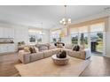 Bright and airy living room with a large sectional sofa and access to the backyard at 8077 Fort Hill Way, Myrtle Beach, SC 29579