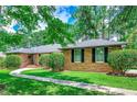 Lovely brick home showcasing a walkway and trimmed shrubs adding to its curb appeal at 8209 Timber Ridge Rd., Conway, SC 29526