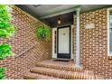 Inviting brick porch with hanging fern and charming house number at 8209 Timber Ridge Rd., Conway, SC 29526