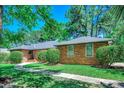 Beautiful brick home with a well-manicured lawn and paved walkway at 8209 Timber Ridge Rd., Conway, SC 29526