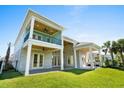Expansive back porch features a covered patio, outdoor fans, and lush green lawn at 985 Shipmaster Ave., Myrtle Beach, SC 29579