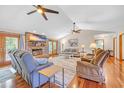 Cozy living room with a brick fireplace, ceiling fans, hardwood floors, and French doors leading to the outside at 1014 Academy Dr., Conway, SC 29526