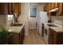 Traditional kitchen features wood cabinets, and white appliances at 1145 Forest Dr., North Myrtle Beach, SC 29582