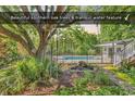Backyard featuring southern oak trees, a tranquil water feature, and a private pool at 130 Hagar Brown Rd., Murrells Inlet, SC 29576