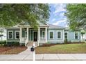 Inviting home featuring light blue siding, a charming front porch, and beautifully landscaped front yard at 1400 James Island Ave., North Myrtle Beach, SC 29582