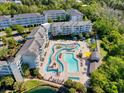 Aerial view of community pool and amenities, highlighting spacious decks and lush landscaping at 14290 Ocean Highway # 222, Pawleys Island, SC 29585