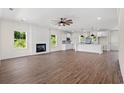 Open-concept living room with fireplace, leading into a kitchen with pendant lighting and modern finishes at 1503 Red Bluff Rd., Loris, SC 29569
