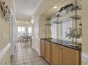 Bright hallway with tile flooring, built in bar with countertop, and dining area in the background at 156 Via Old Sound Blvd. # C, Ocean Isle Beach, NC 28469