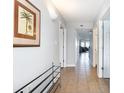 Long hallway with tile floors leading to a living room, features white walls and doors with neutral decor at 1707 Perrin Dr. # 1003, North Myrtle Beach, SC 29582