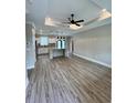 Bright and airy living space featuring wood-look floors, ceiling fan and neutral walls at 1795 Hemingway St., Conway, SC 29527