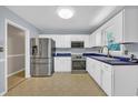 Clean kitchen with stainless steel appliances, white cabinetry, and blue countertops at 1907 Rose St., Conway, SC 29527