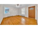 Bright living room features gleaming hardwood floors and lots of natural light from large windows at 1907 Rose St., Conway, SC 29527