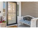 Charming front entrance with a bench, stylish door, and welcoming potted plants at 194 Zostera Dr., Little River, SC 29566
